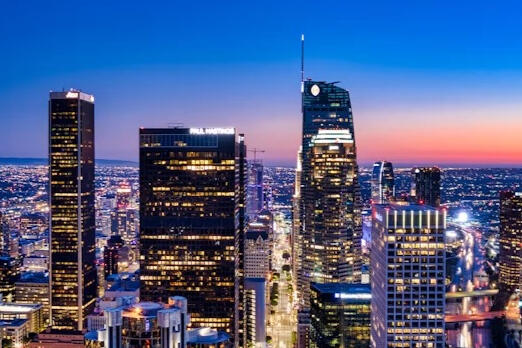 City-scale economic development Professional blue-hour aerial view of downtown Los Angeles, illustrating the scale of coordinated economic development.